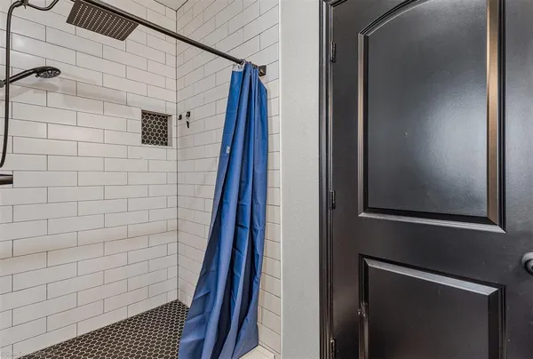 a bathroom with a shower and a sink