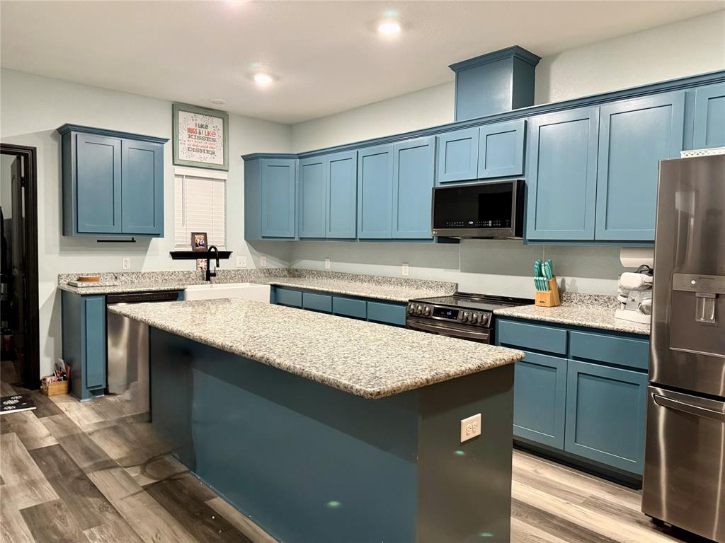 1384 County Road 1235 Point, TX 75472 - Photo 8 of 31 a kitchen with a sink a stove a refrigerator and a oven