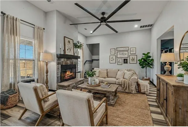 a living room with furniture a fireplace and a window