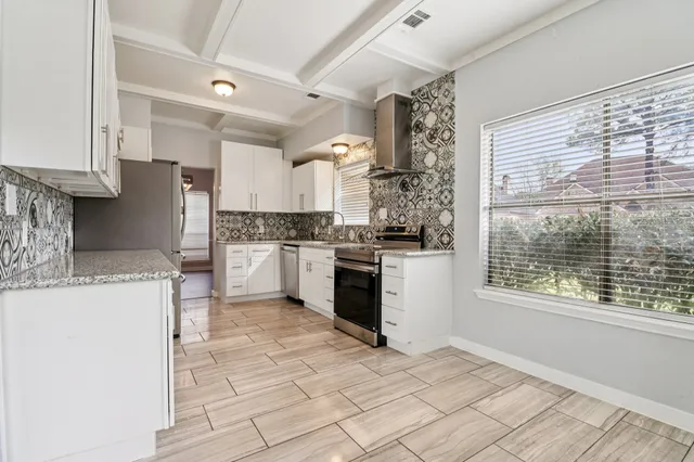 a kitchen with a stove a sink and a refrigerator