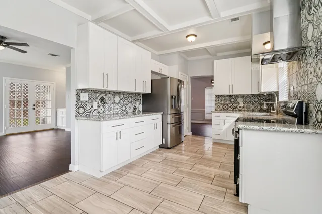 a kitchen with stainless steel appliances a refrigerator sink and cabinets