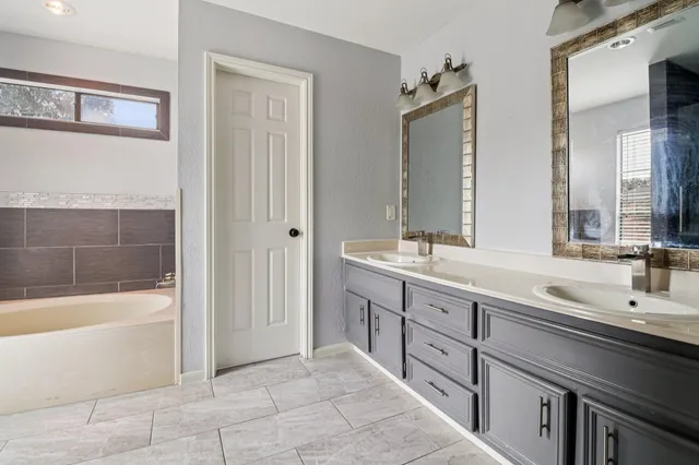 a bathroom with a tub and shower
