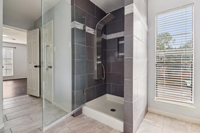 wooden floor in an empty room with a window
