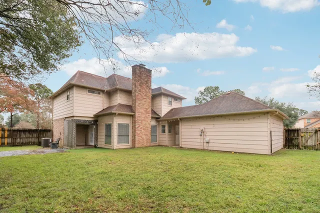 a view of a house with a yard and sitting area