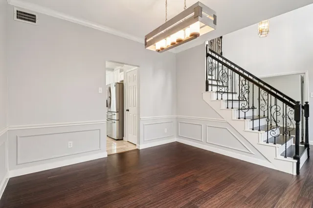 a view of an entryway with wooden floor