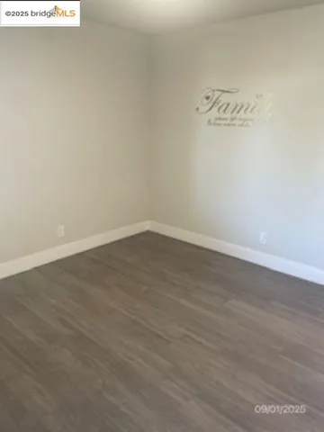 a view of a room with wooden floor