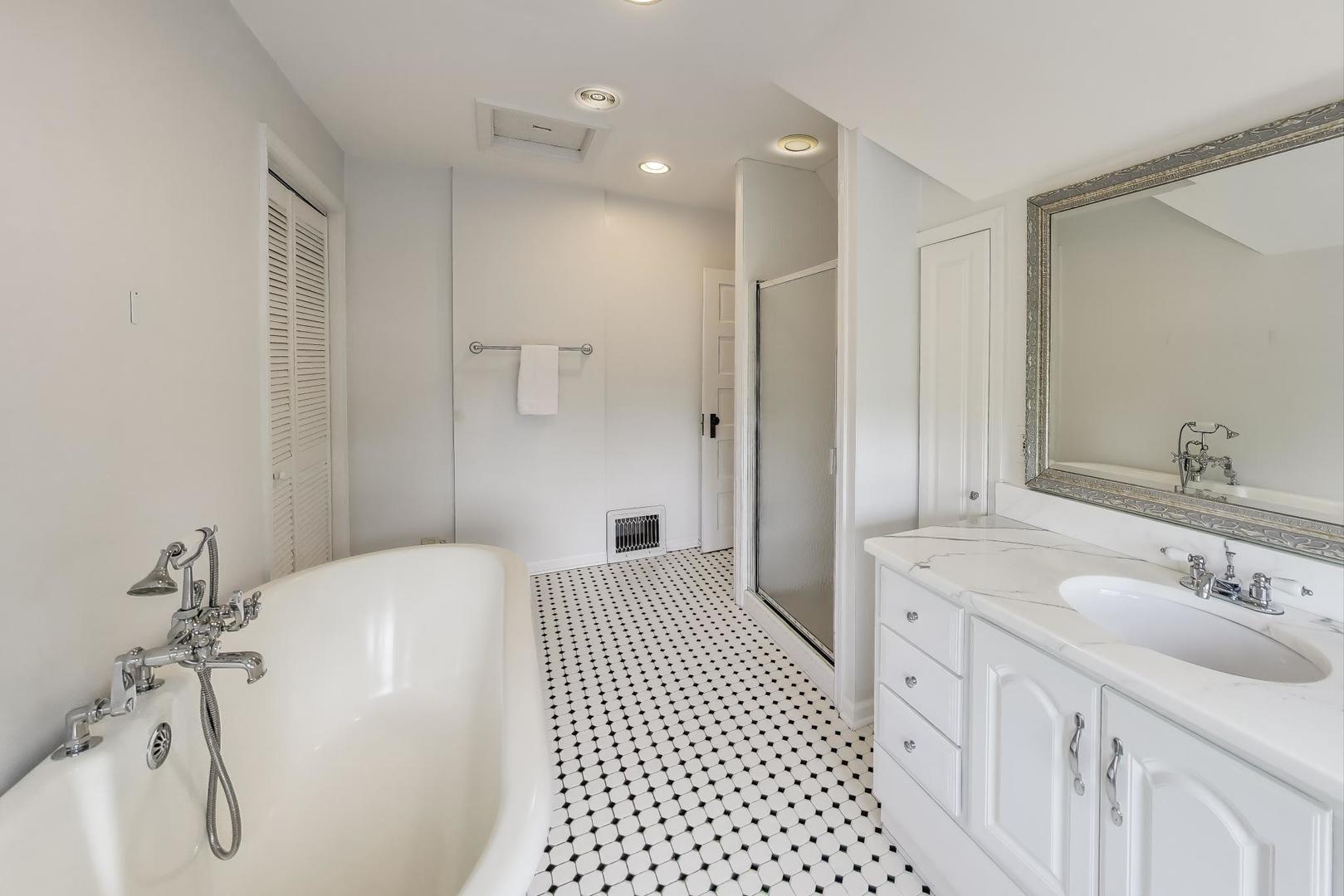 274 Ridge Avenue Winnetka, IL 60093 - Photo 23 of 36 a bathroom with a double vanity sink a mirror and a shower