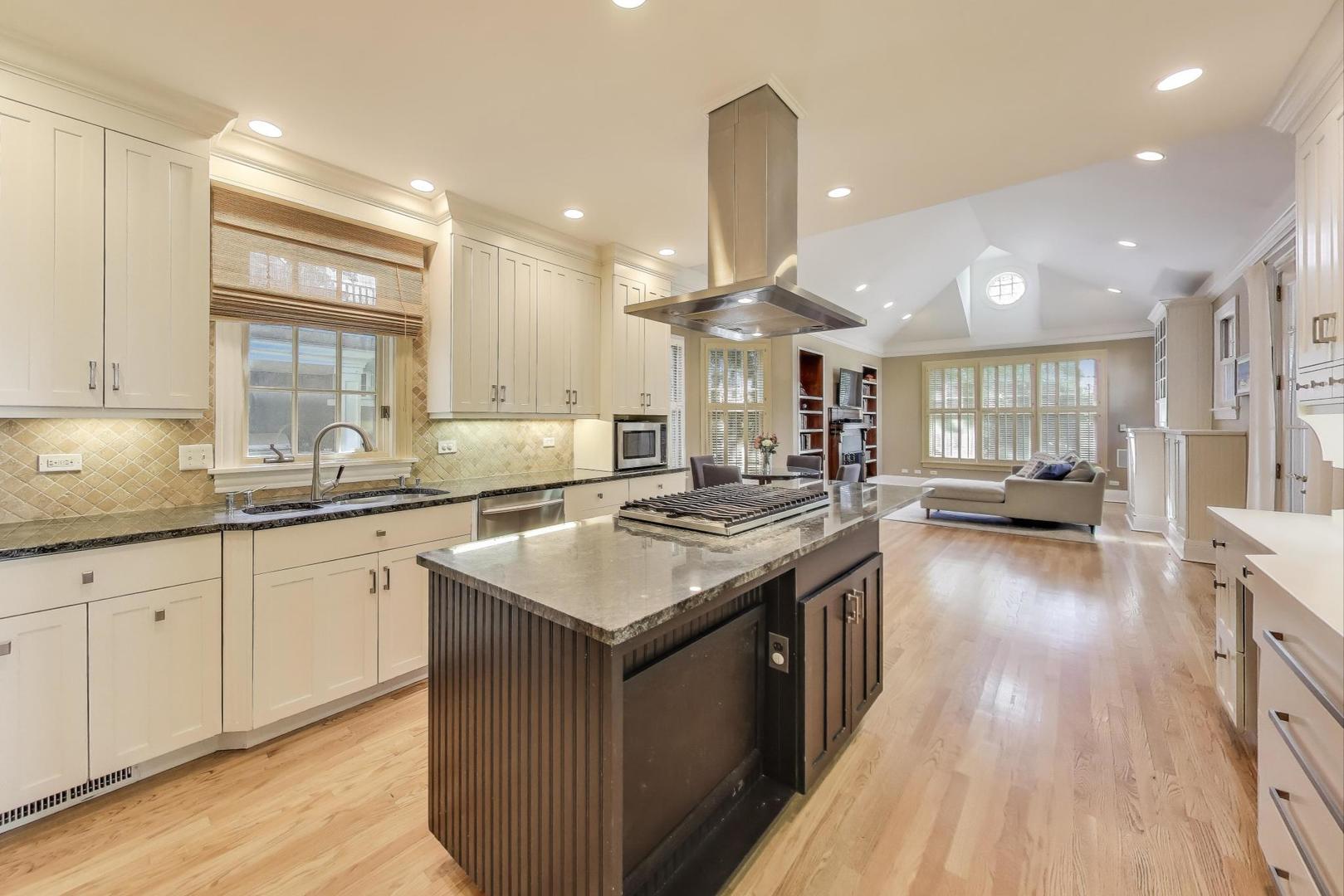 274 Ridge Avenue Winnetka, IL 60093 - Photo 7 of 36 a kitchen with a sink stove and wooden cabinets