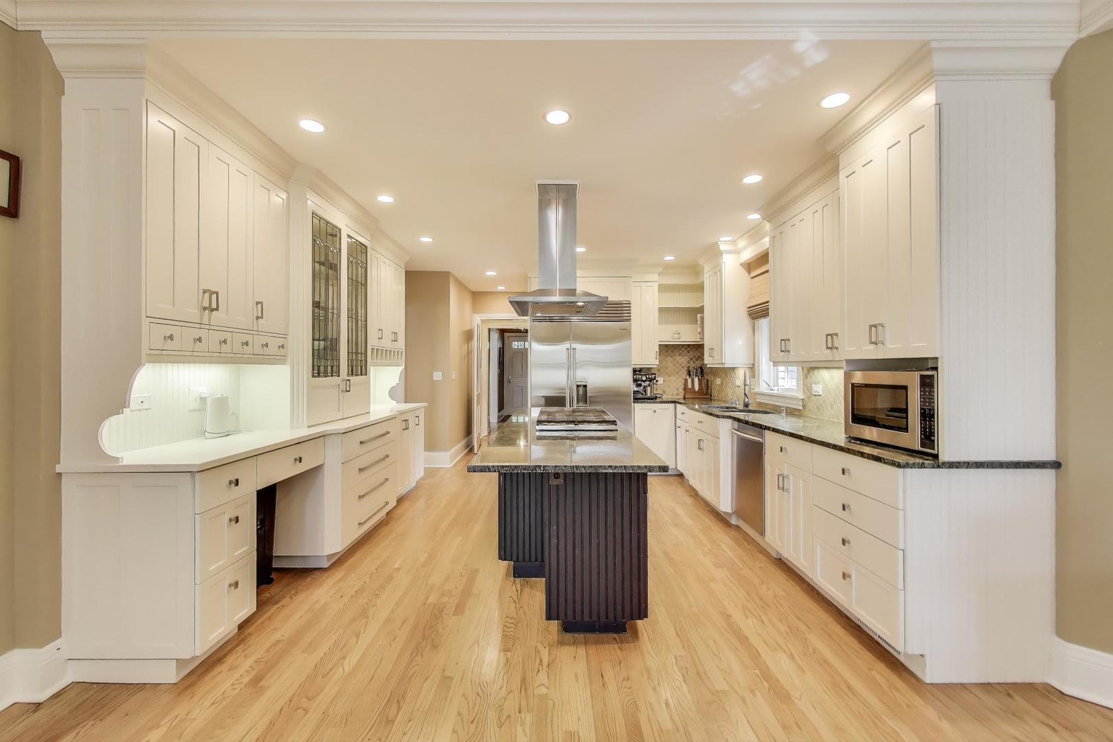274 Ridge Avenue Winnetka, IL 60093 - Photo 8 of 36 a large kitchen with stainless steel appliances kitchen island granite countertop a large center island and a stove top oven