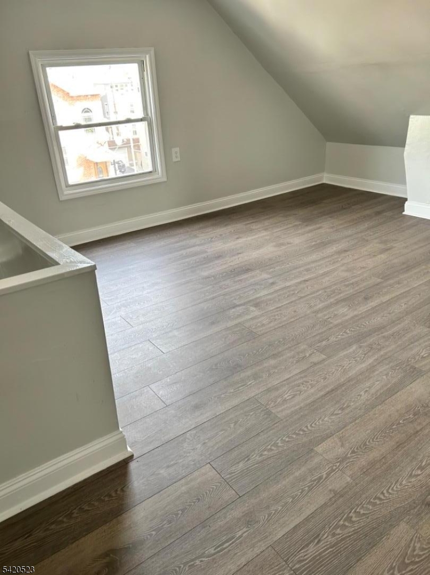 222 Inslee Place, Unit 2 Elizabeth Port, NJ 07206 - Photo 13 of 15 an empty room with wooden floor and windows