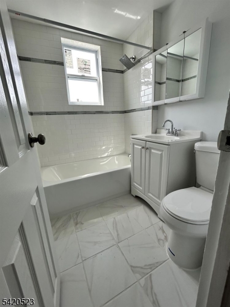 222 Inslee Place, Unit 2 Elizabeth Port, NJ 07206 - Photo 2 of 15 a bathroom with a sink a toilet and bathtub