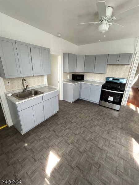 222 Inslee Place, Unit 2 Elizabeth Port, NJ 07206 - Photo 3 of 15 a kitchen with a stove a sink and a refrigerator