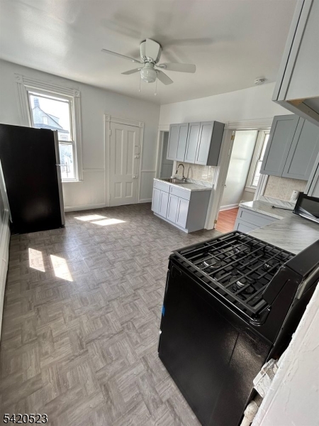 222 Inslee Place, Unit 2 Elizabeth Port, NJ 07206 - Photo 7 of 15 a kitchen with granite countertop a stove and a refrigerator