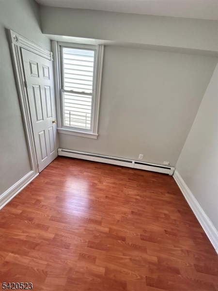 222 Inslee Place, Unit 2 Elizabeth Port, NJ 07206 - Photo 10 of 15 an empty room with wooden floor and windows