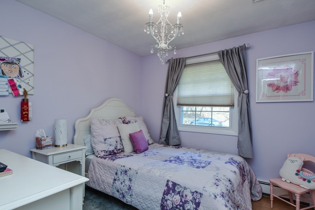 18 Raleigh Road Framingham, MA 01701 - Photo 11 of 18 a bedroom with a bed and a chandelier