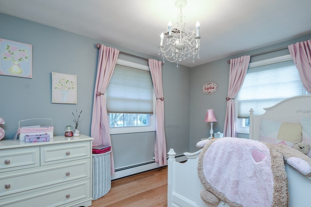 18 Raleigh Road Framingham, MA 01701 - Photo 12 of 18 a spacious bedroom with furniture and a chandelier