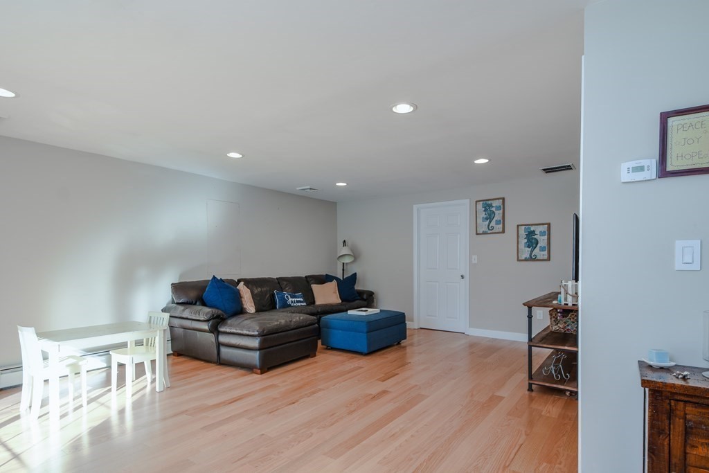 18 Raleigh Road Framingham, MA 01701 - Photo 16 of 18 a living room with furniture and a wooden floor