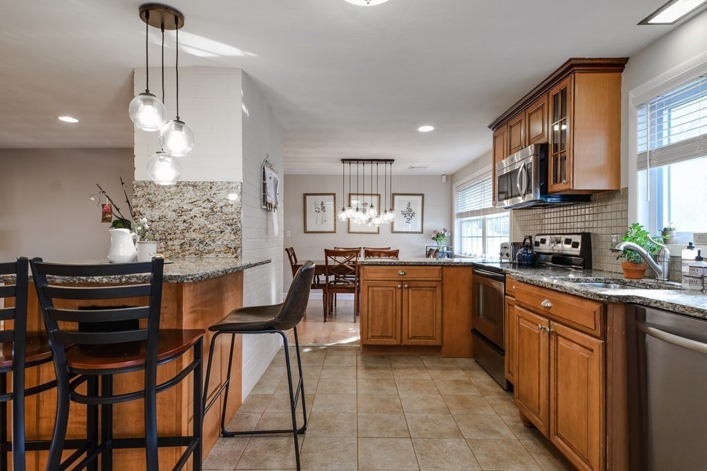 18 Raleigh Road Framingham, MA 01701 - Photo 9 of 18 a kitchen with stainless steel appliances kitchen island granite countertop a stove a sink and a refrigerator