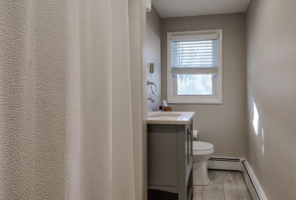 18 Raleigh Road Framingham, MA 01701 - Photo 10 of 18 a bathroom with a toilet a sink and a window