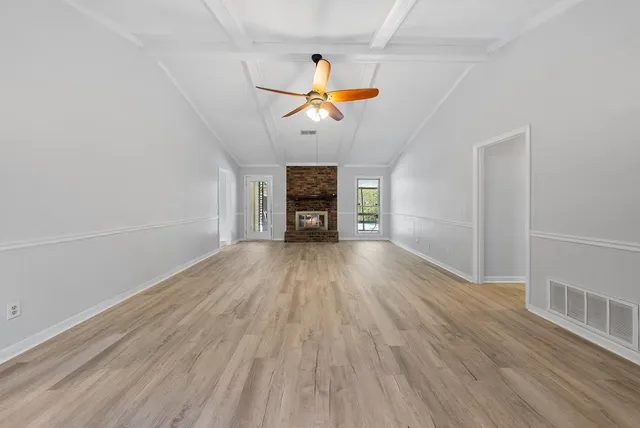 wooden floor in an empty room with a window