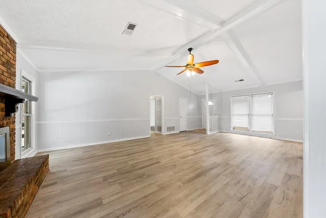 wooden floor in an empty room with a window