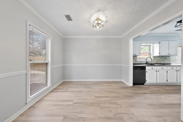 a view of a kitchen with an empty space and window