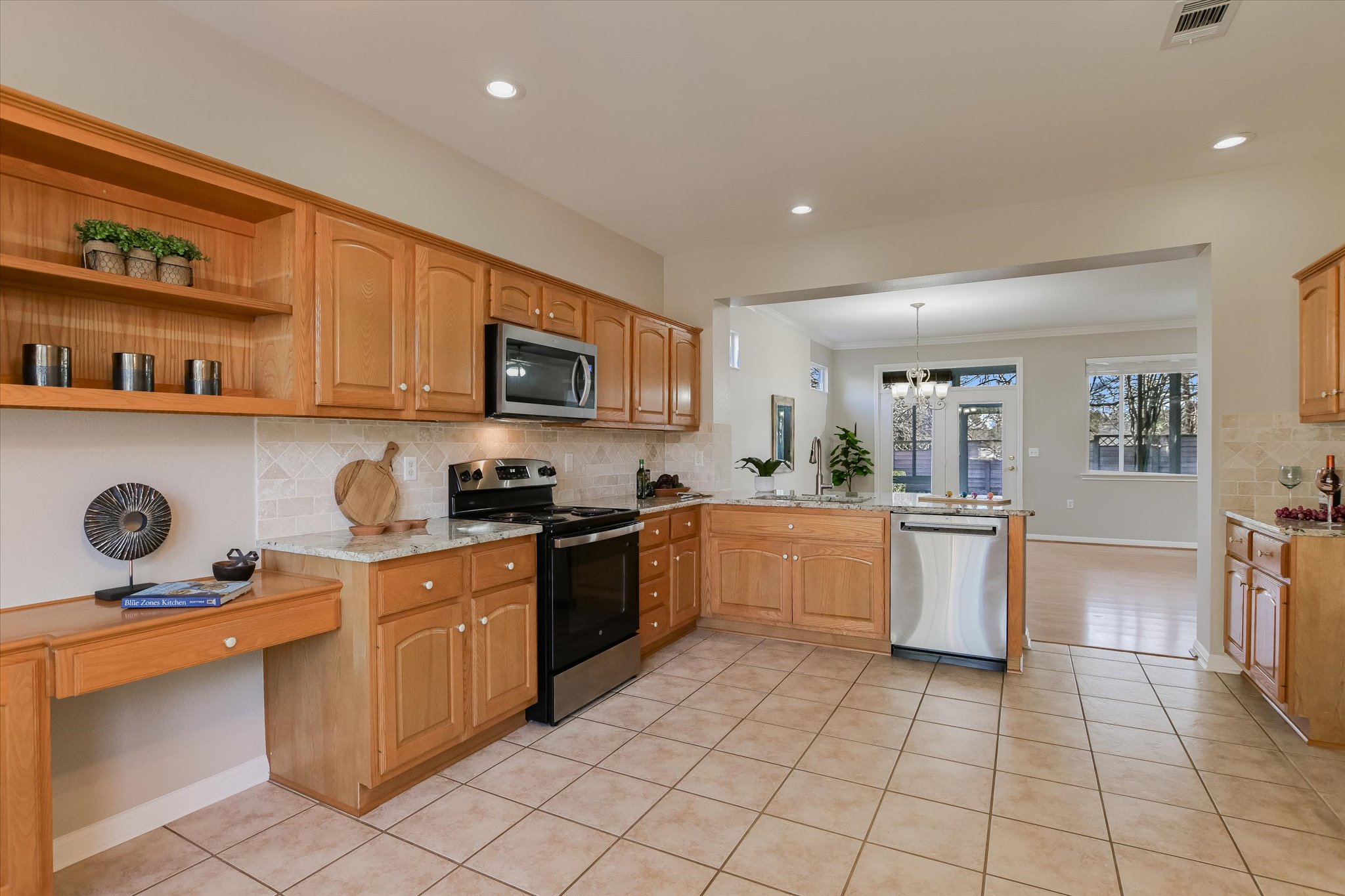 265 Trail Of The Flowers Georgetown, TX 78633 - Photo 12 of 20 a kitchen with a sink a stove top oven a counter space and cabinets