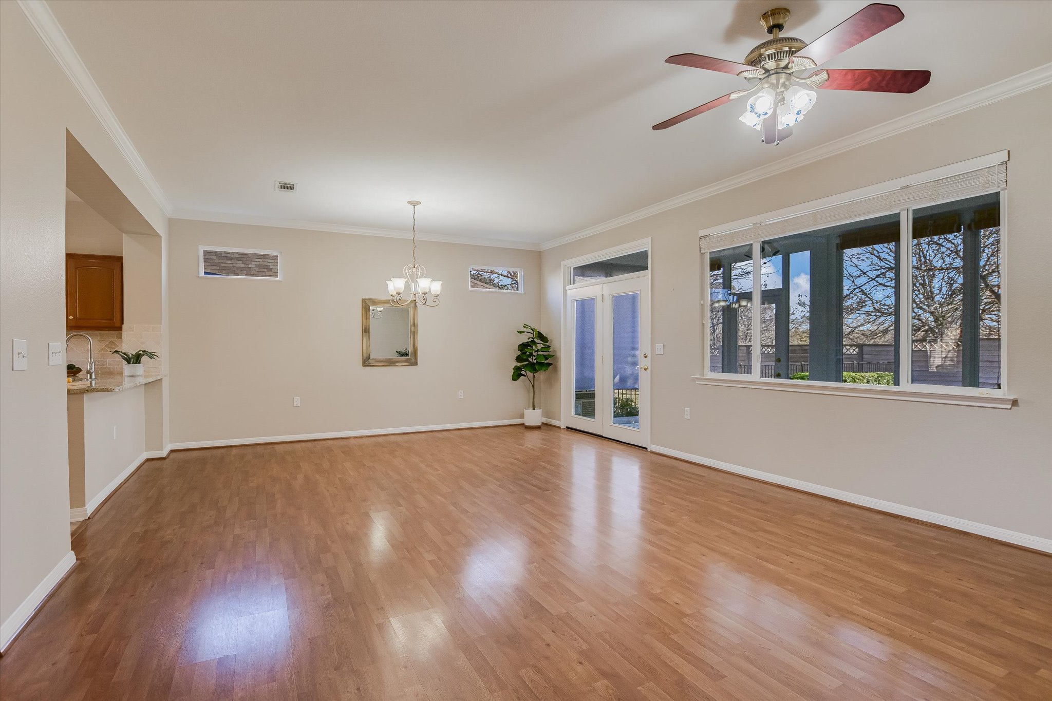 265 Trail Of The Flowers Georgetown, TX 78633 - Photo 6 of 20 a view of an empty room with a window and wooden floor