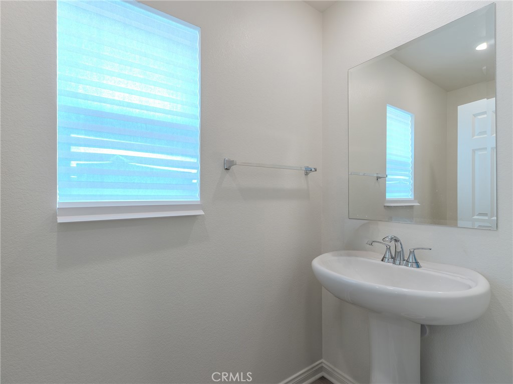 25602 Pne Rdg Road Homeland, CA 92548 - Photo 6 of 35 a bathroom with a sink and a mirror