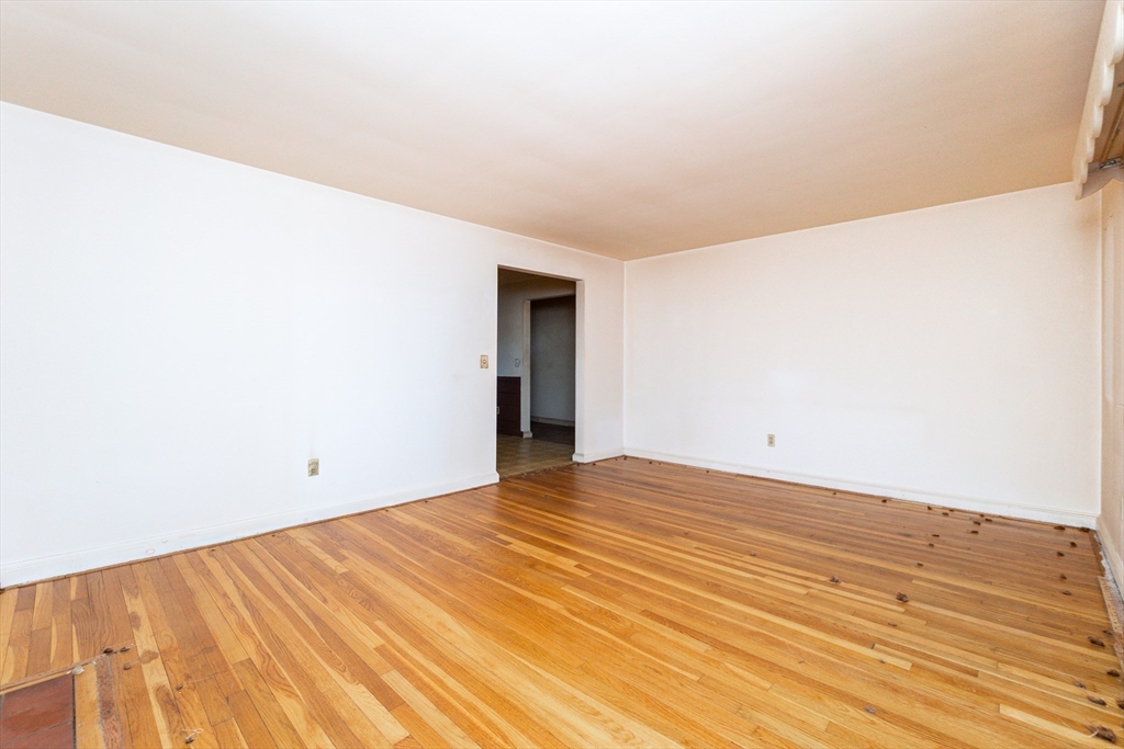 51 Pincushion Road Framingham, MA 01702 - Photo 11 of 42 a view of empty room with wooden floor