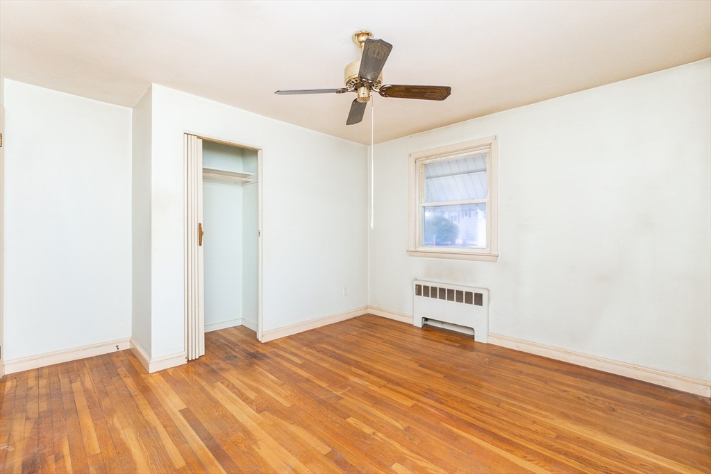 51 Pincushion Road Framingham, MA 01702 - Photo 14 of 42 a view of a livingroom with wooden floor a ceiling fan and windows