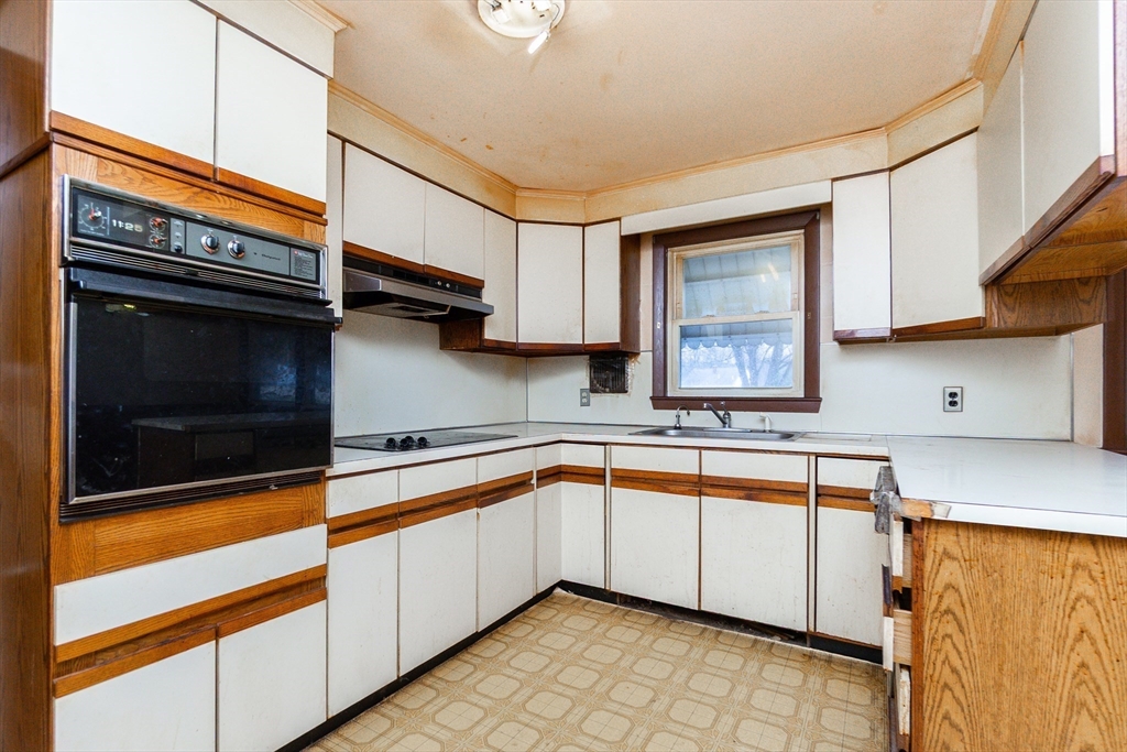 51 Pincushion Road Framingham, MA 01702 - Photo 4 of 42 a kitchen with stainless steel appliances granite countertop a sink stove and microwave
