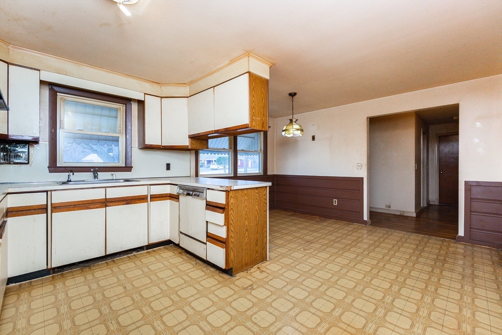 51 Pincushion Road Framingham, MA 01702 - Photo 5 of 42 a kitchen with stainless steel appliances a sink cabinets and a window