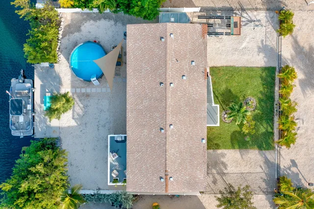 a view of house with backyard and garden