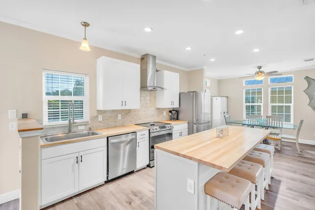 a kitchen with a sink a stove a refrigerator and cabinets
