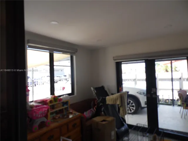 a living room with granite countertop furniture and a flat screen tv