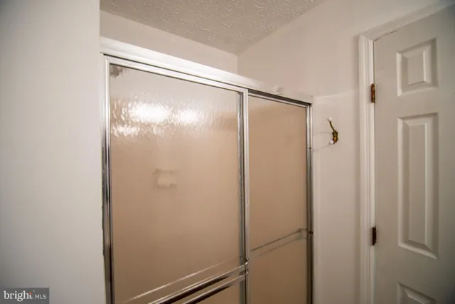 a bathroom with a glass shower door
