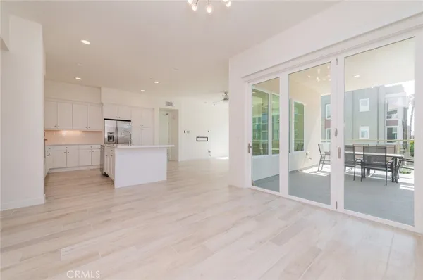 a large white kitchen with a large window
