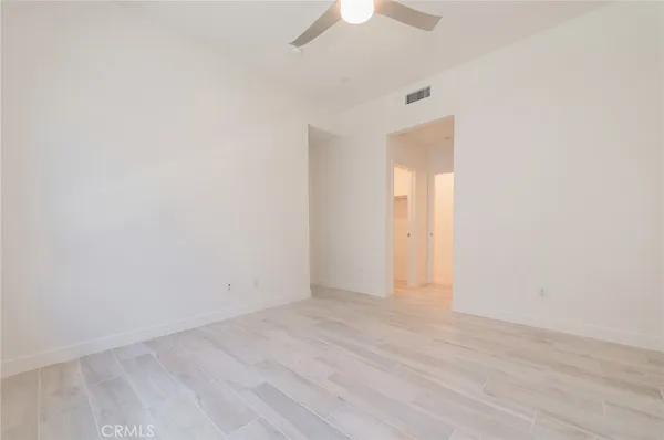 an empty room with wooden floor and door