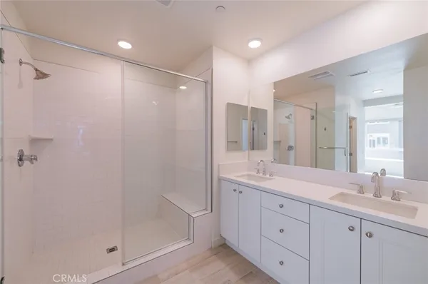 a spacious bathroom with double sink and a mirror