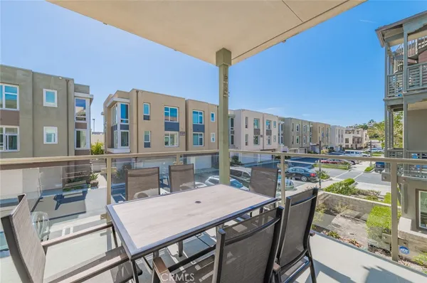 a view of a patio with table and chairs and potted plants