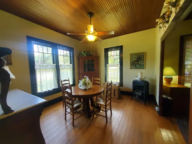 a view of a dining room with furniture and window