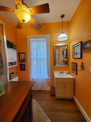 a room with table chairs and wooden floor