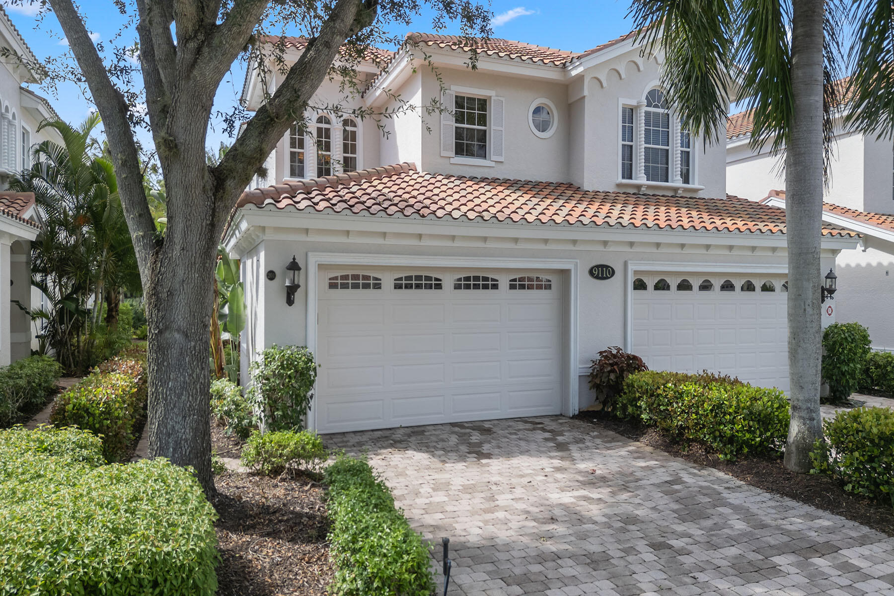 9110 Cascada Way, Unit 201 Naples, FL 34114 - Photo 30 of 50 a front view of a house with a garden