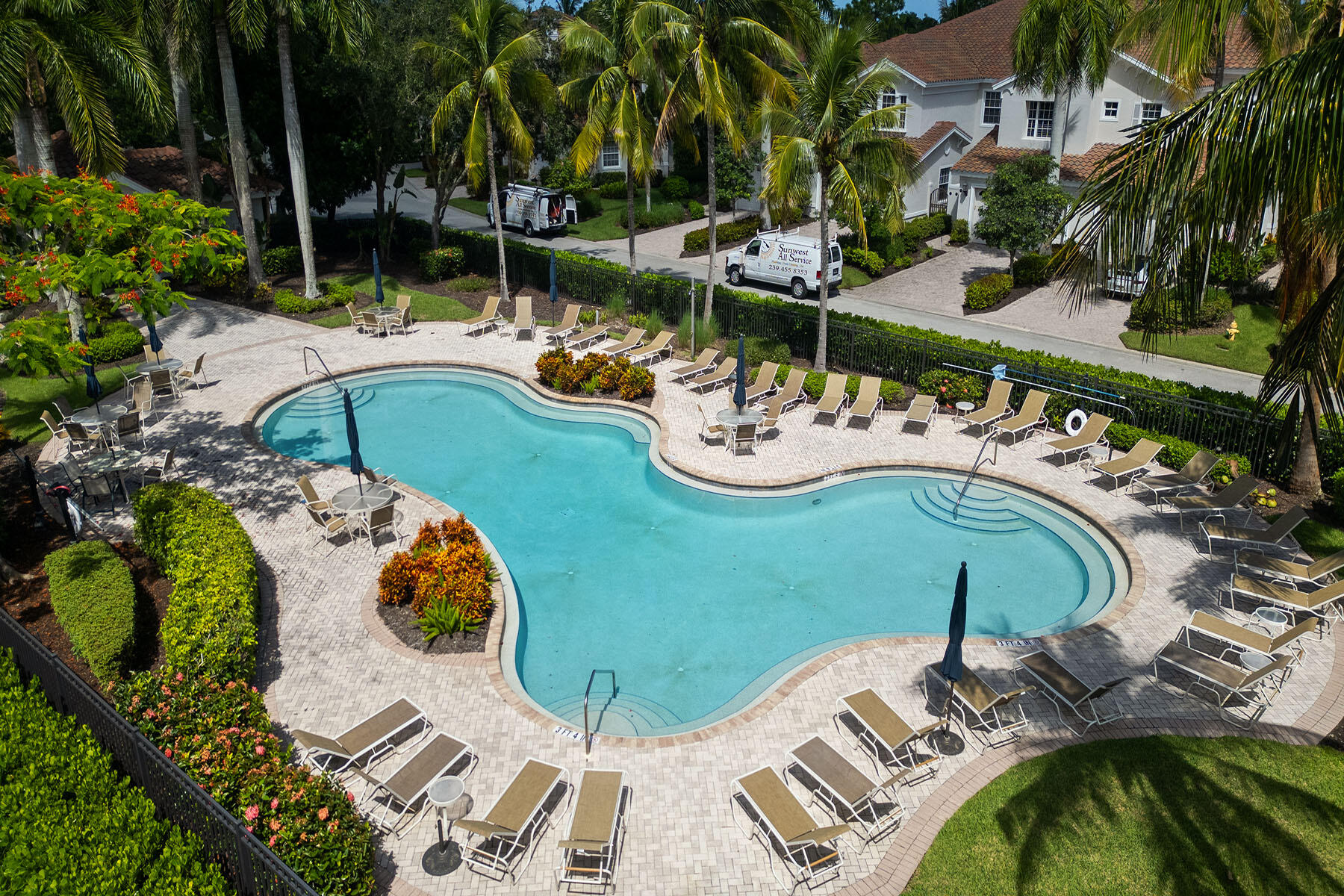 9110 Cascada Way, Unit 201 Naples, FL 34114 - Photo 33 of 50 a view of a swimming pool and lounge chairs