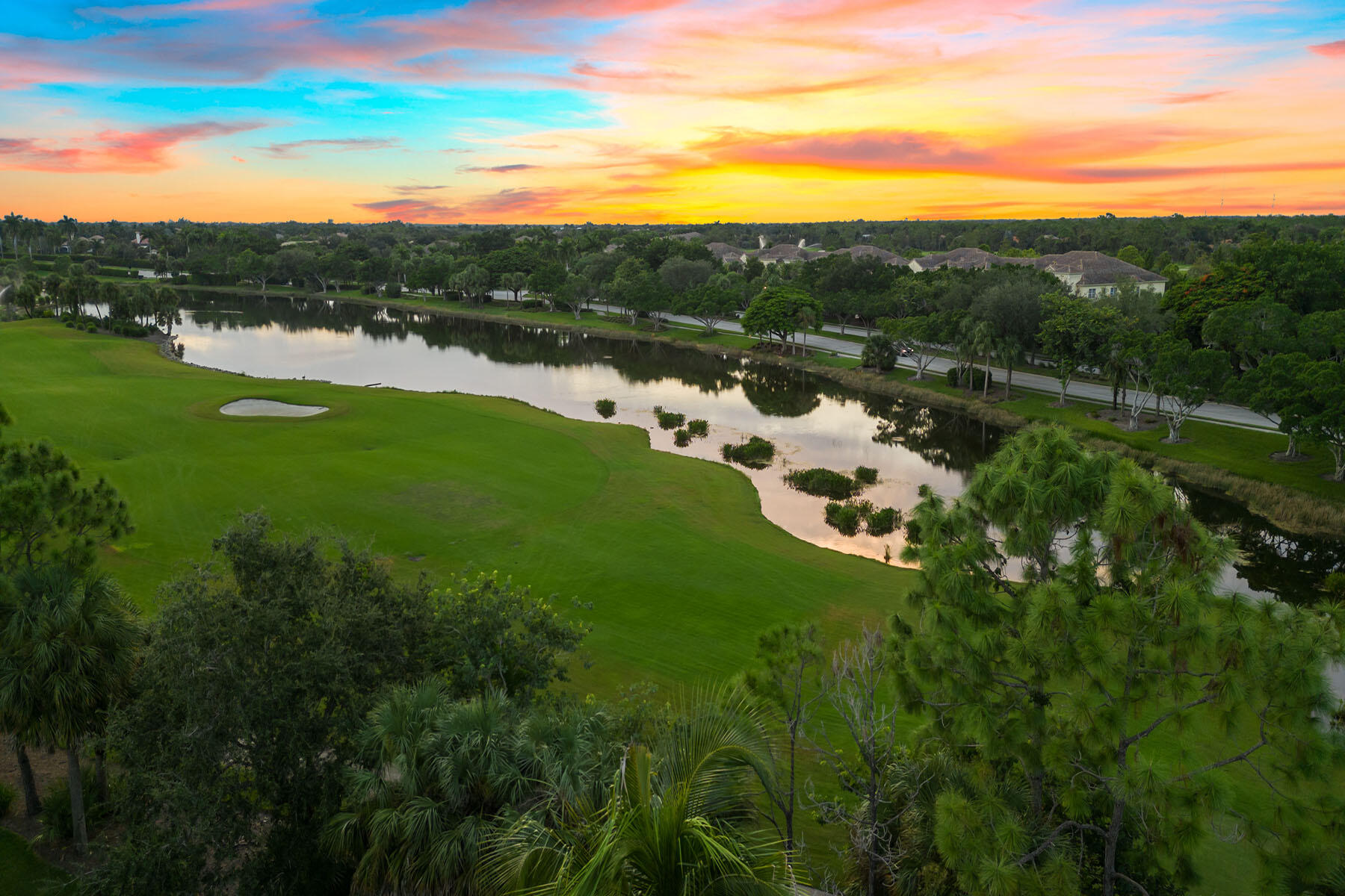 9110 Cascada Way, Unit 201 Naples, FL 34114 - Photo 35 of 50 a view of a lake with houses in the background