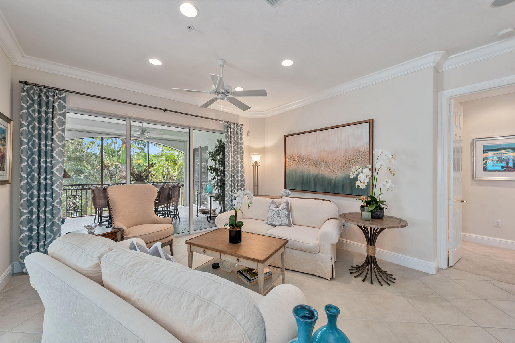 9110 Cascada Way, Unit 201 Naples, FL 34114 - Photo 4 of 50 a living room with furniture and large windows