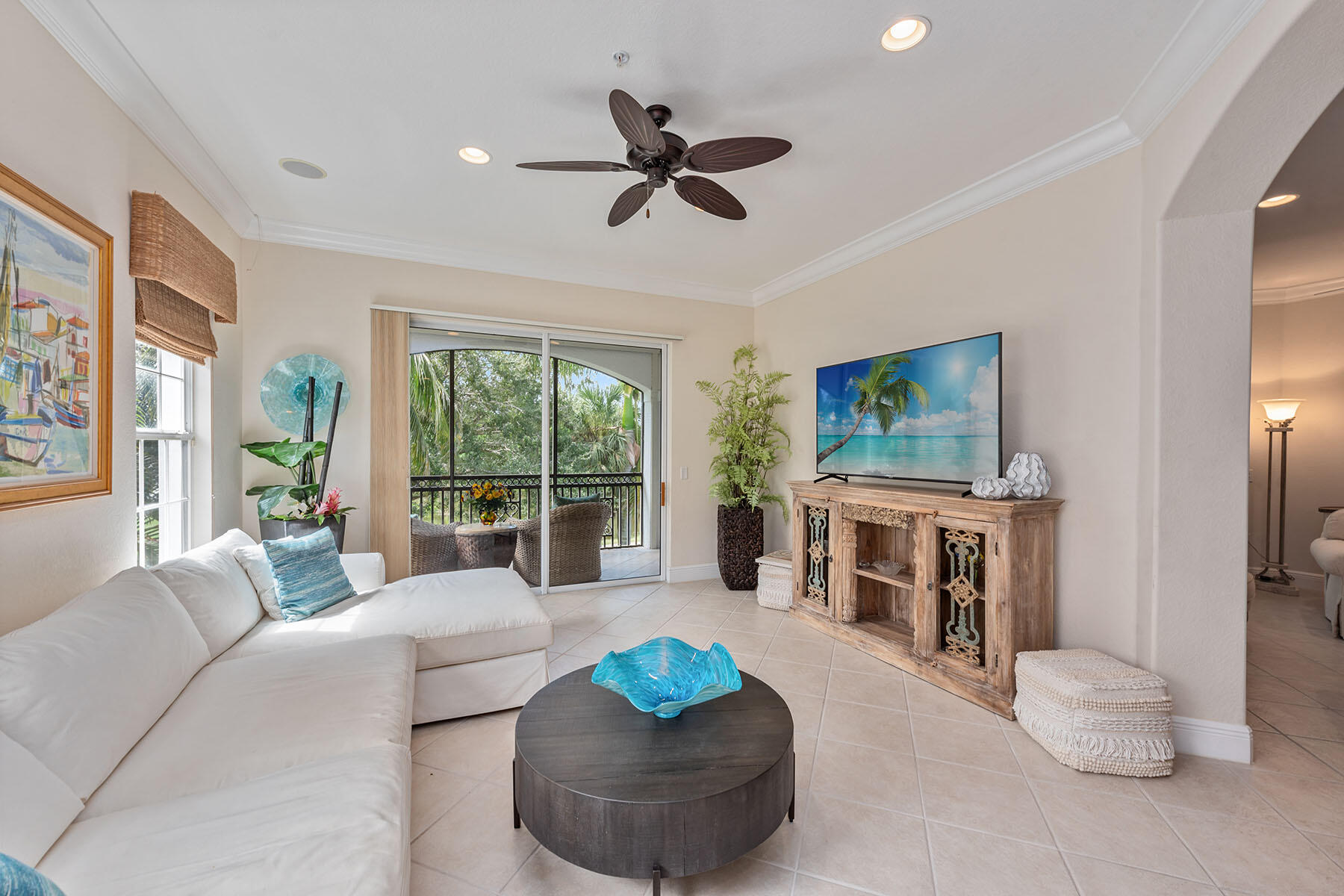 9110 Cascada Way, Unit 201 Naples, FL 34114 - Photo 7 of 50 a living room with furniture and a flat screen tv