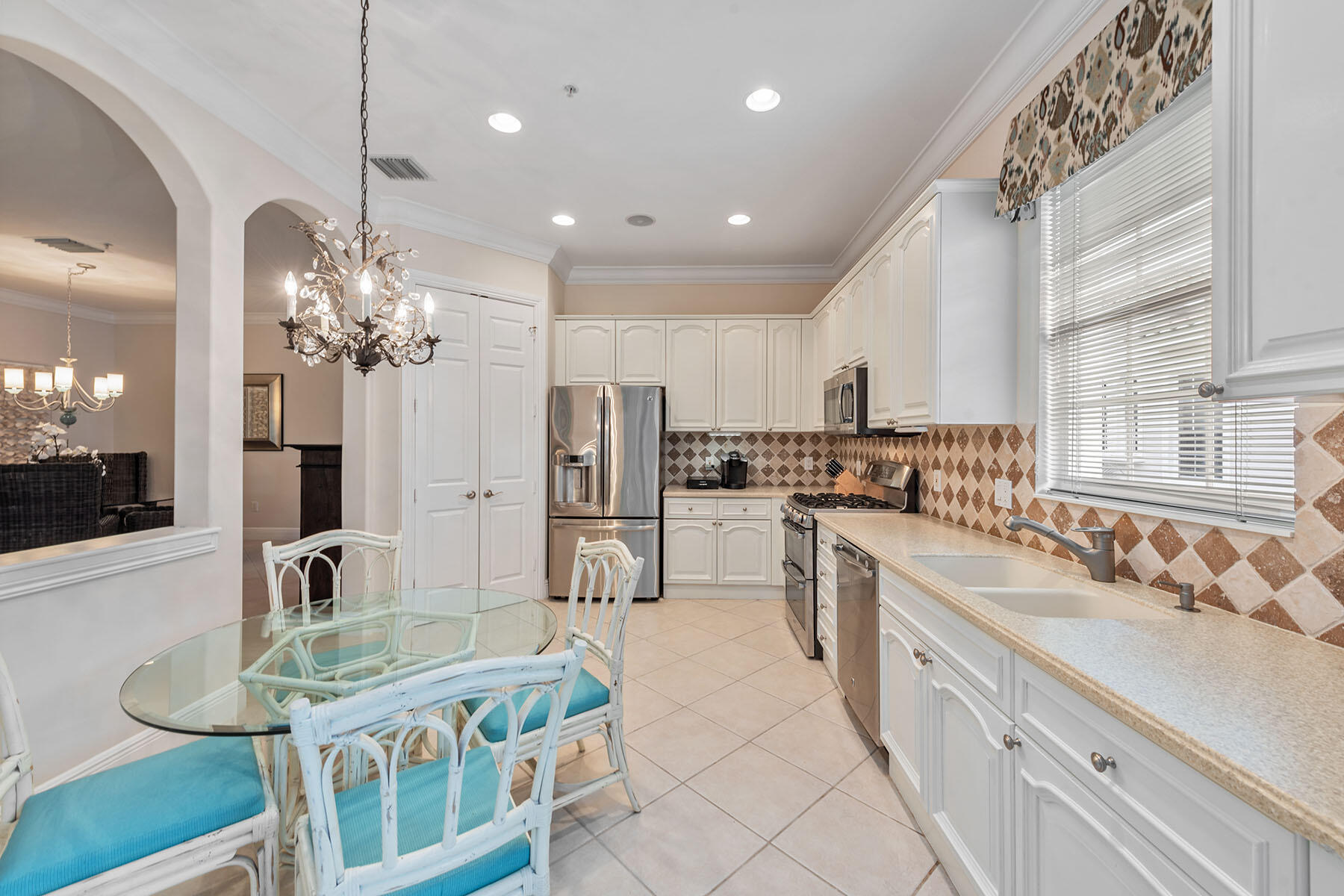 9110 Cascada Way, Unit 201 Naples, FL 34114 - Photo 8 of 50 a large kitchen with kitchen island a sink table and chairs