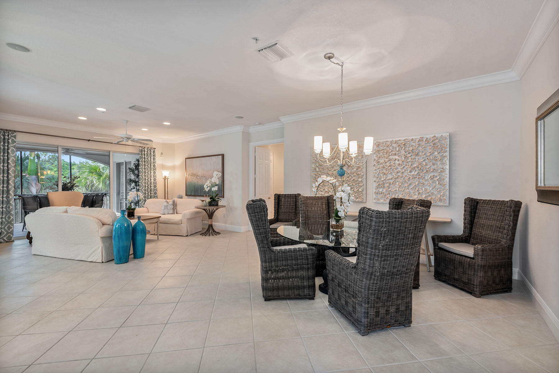 9110 Cascada Way, Unit 201 Naples, FL 34114 - Photo 10 of 50 a living room with couches and kitchen view with wooden floor